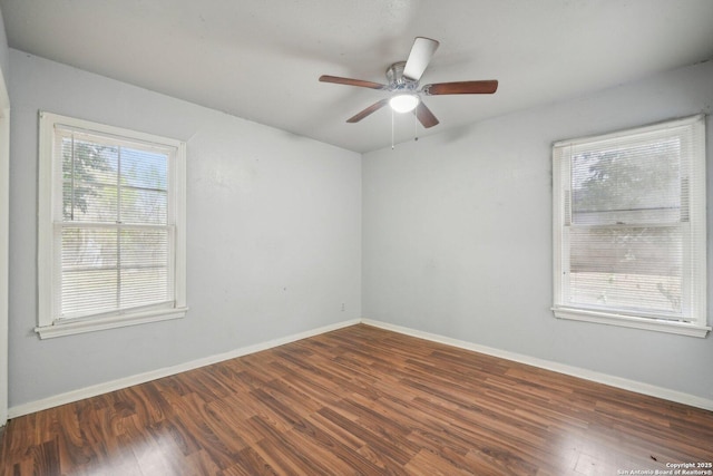 spare room featuring dark hardwood / wood-style flooring and ceiling fan