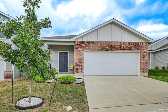 view of front of home with a front yard and a garage