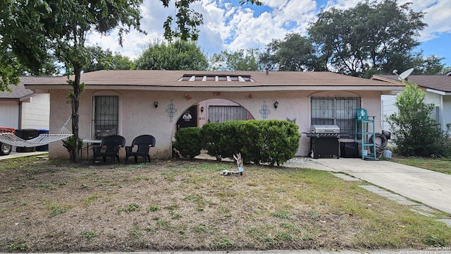 ranch-style house with a front lawn