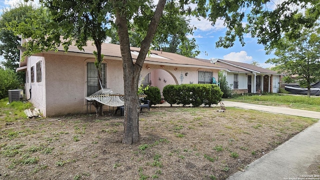 ranch-style house featuring cooling unit