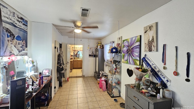 interior space featuring ceiling fan and light tile patterned floors