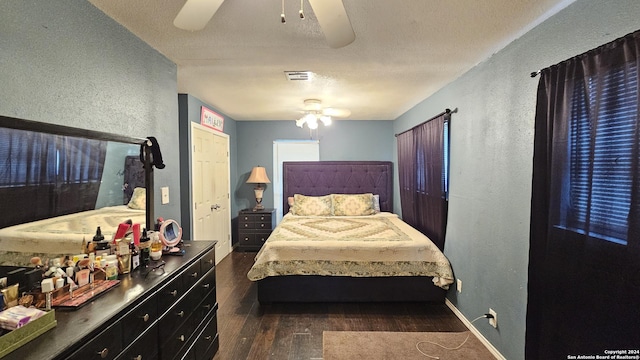 bedroom featuring a textured ceiling, dark hardwood / wood-style flooring, and ceiling fan