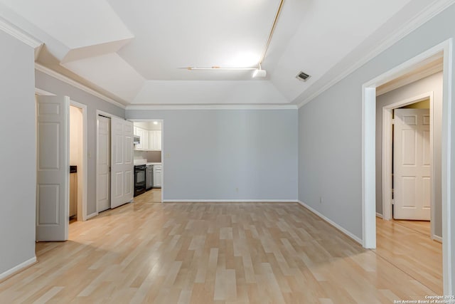 interior space featuring a raised ceiling, crown molding, and light hardwood / wood-style floors