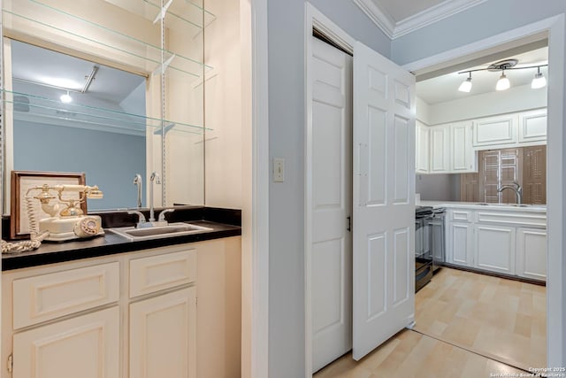 kitchen featuring white cabinets, black range with electric stovetop, ornamental molding, and sink