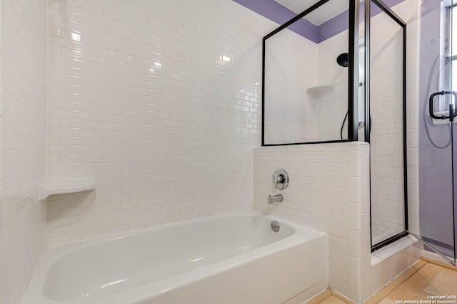 bathroom featuring separate shower and tub