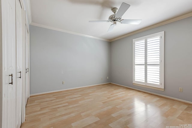 empty room with crown molding, ceiling fan, and light wood-type flooring