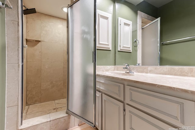 bathroom featuring vanity and a shower with shower door