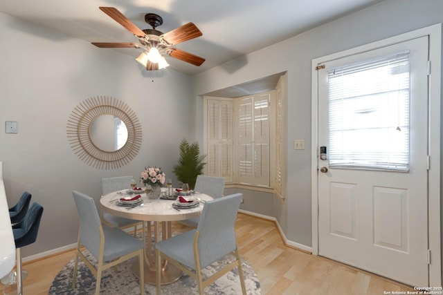 dining space featuring light hardwood / wood-style floors, ceiling fan, and a healthy amount of sunlight