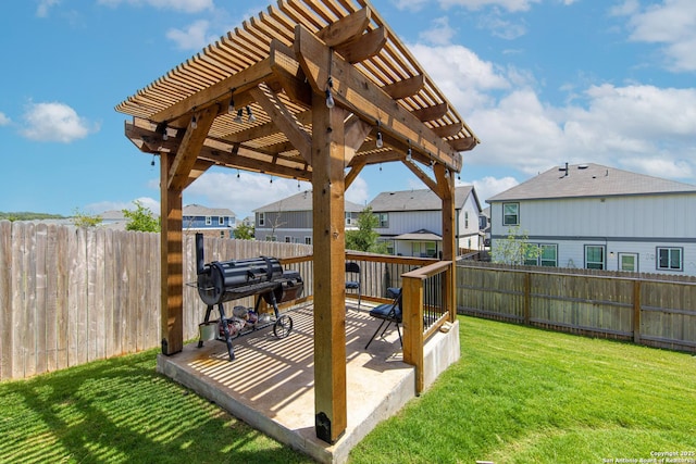 wooden terrace featuring a pergola, a lawn, and a patio