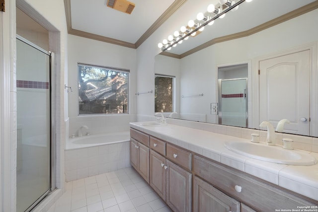 bathroom with tile patterned floors, vanity, crown molding, and shower with separate bathtub