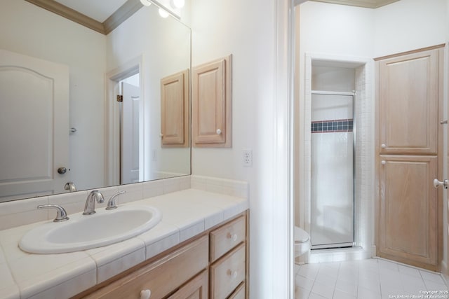 bathroom featuring tile patterned floors, toilet, vanity, a shower with shower door, and ornamental molding