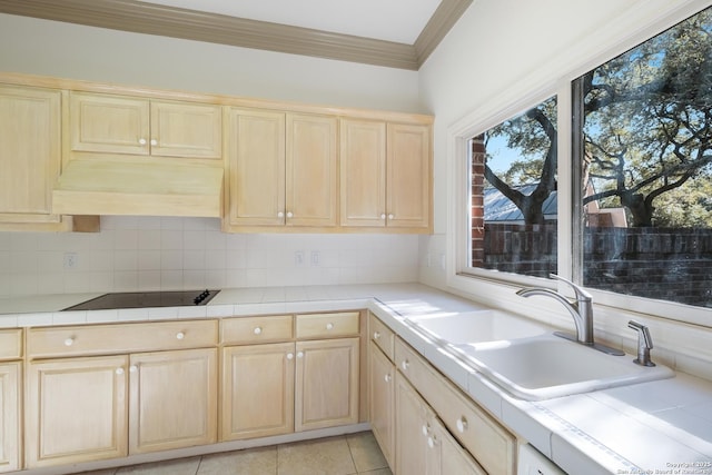 kitchen with sink, tasteful backsplash, tile countertops, black electric stovetop, and light tile patterned floors