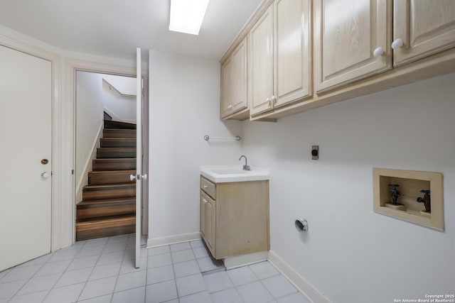 laundry room with hookup for an electric dryer, cabinets, sink, and hookup for a washing machine