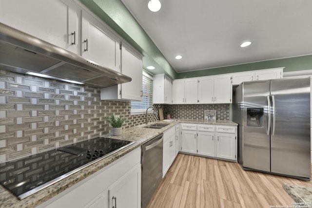 kitchen featuring decorative backsplash, light stone counters, stainless steel appliances, sink, and white cabinets