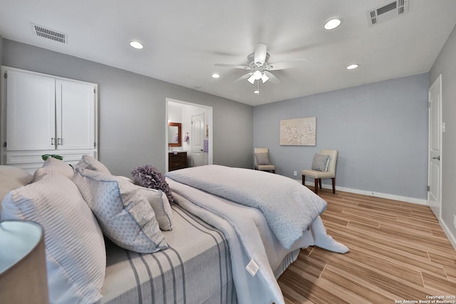 bedroom with ceiling fan, light hardwood / wood-style floors, and ensuite bath