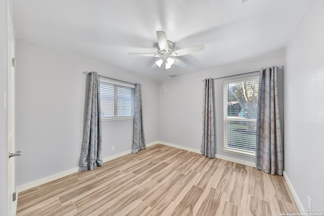 unfurnished room with light wood-type flooring and ceiling fan