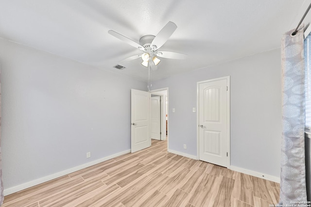 spare room featuring light wood-type flooring and ceiling fan