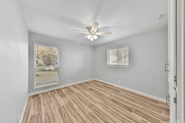 empty room featuring ceiling fan and light hardwood / wood-style flooring