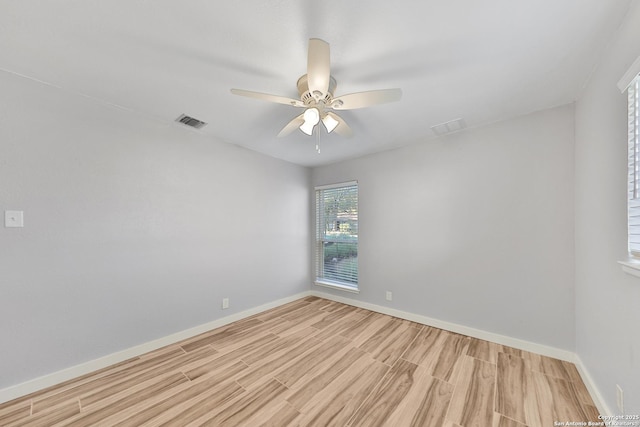 unfurnished room with ceiling fan and light wood-type flooring