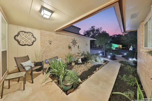 view of patio terrace at dusk