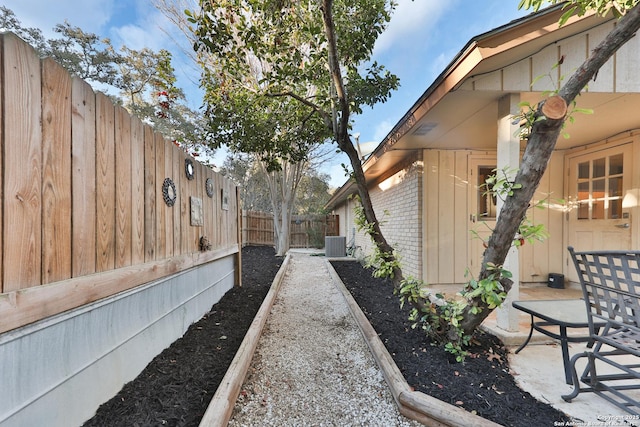 view of yard with central AC unit and a patio area