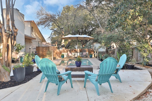 view of patio with a fenced in pool