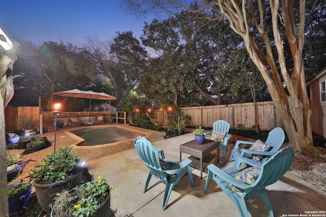 view of patio terrace at dusk