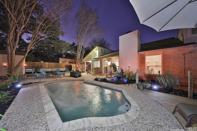 view of swimming pool with a deck and a patio area