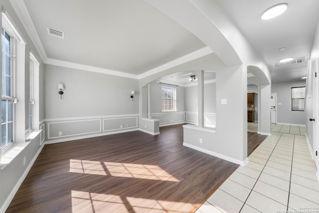 empty room with tile patterned floors and ornamental molding