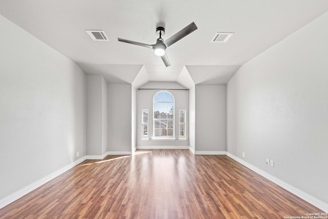 unfurnished living room with lofted ceiling, dark wood-type flooring, and ceiling fan