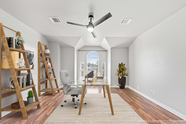 home office featuring ceiling fan, vaulted ceiling, and hardwood / wood-style floors