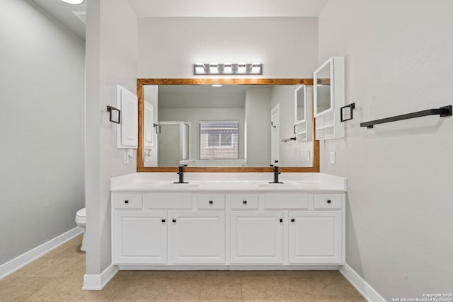 bathroom with vanity, tile patterned flooring, a shower with shower door, and toilet