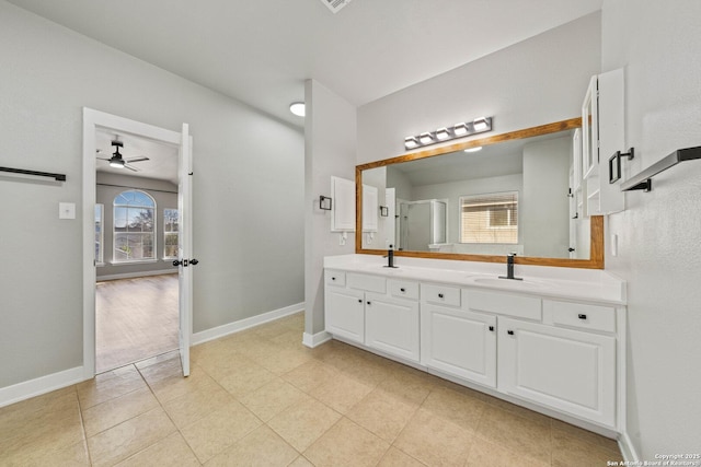 bathroom with an enclosed shower, vanity, and ceiling fan