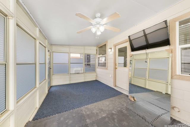 unfurnished sunroom featuring ceiling fan and cooling unit