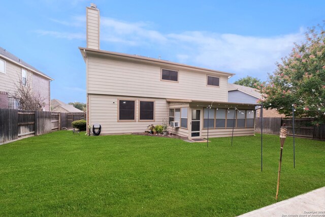 back of house featuring cooling unit, a lawn, and a sunroom