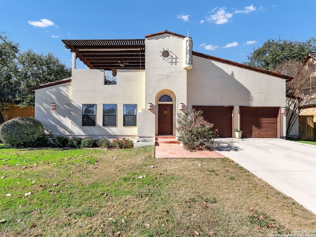 mediterranean / spanish home with a garage and a front lawn