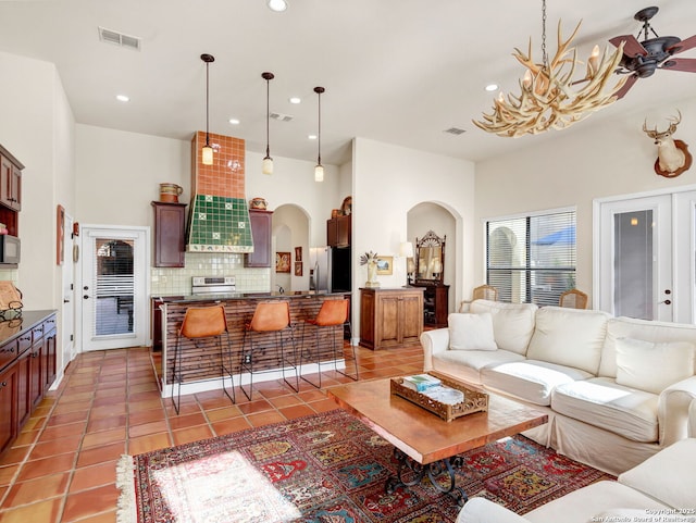 tiled living room featuring ceiling fan