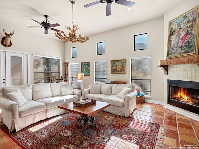 living room with tile patterned flooring, ceiling fan, and a fireplace