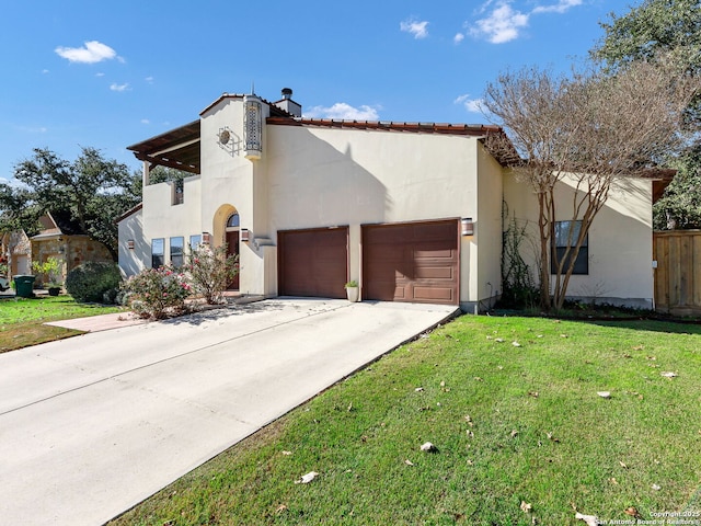 mediterranean / spanish-style house featuring a garage and a front lawn