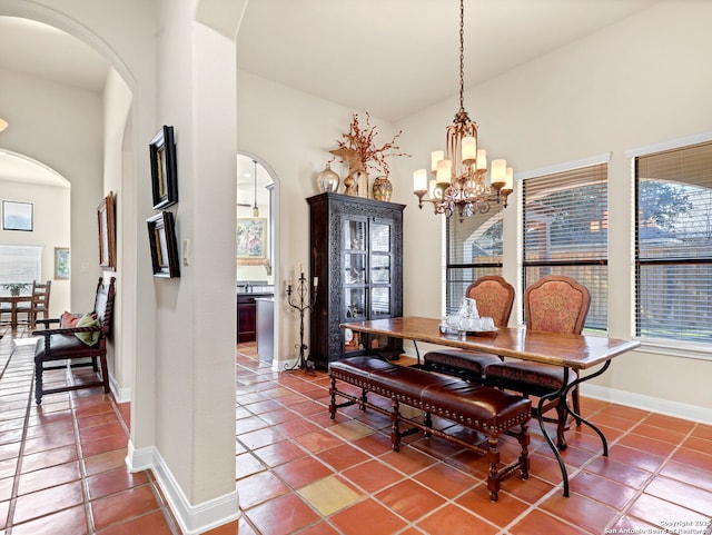 tiled dining area with a chandelier