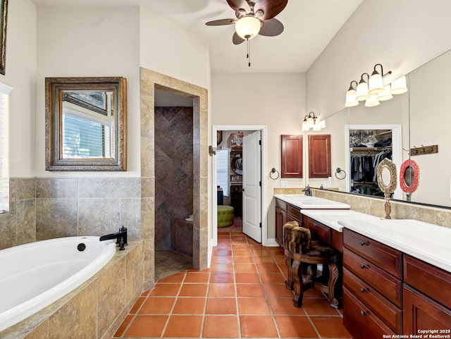 bathroom with tile patterned floors, vanity, ceiling fan, and shower with separate bathtub