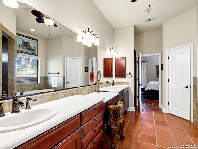 bathroom with tile patterned flooring, vanity, and ceiling fan