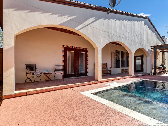 back of property featuring a patio and french doors