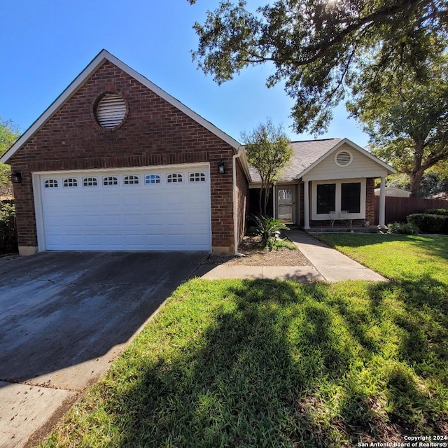 view of front of house with a garage and a front lawn