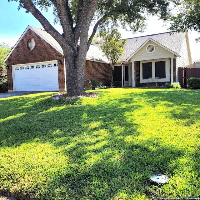 ranch-style house featuring a front yard and a garage