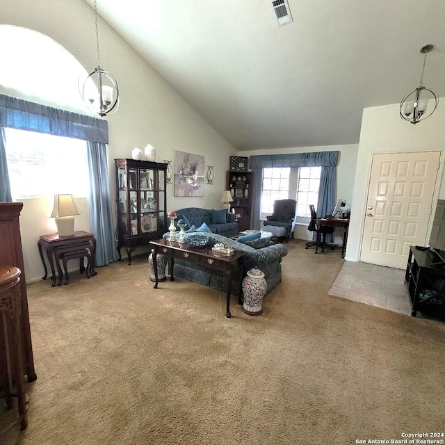 living room with carpet flooring, a notable chandelier, and high vaulted ceiling