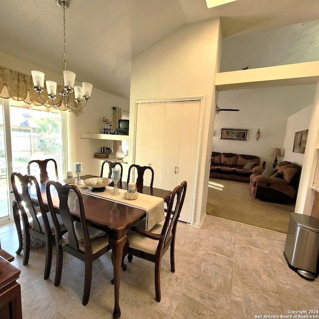 carpeted dining area with an inviting chandelier and vaulted ceiling