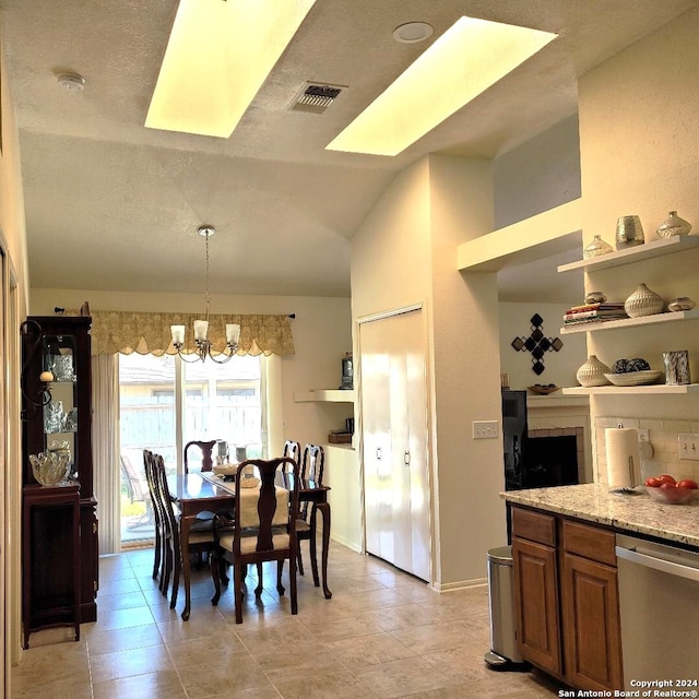 dining space with a notable chandelier and lofted ceiling