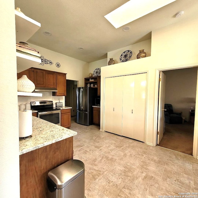 kitchen with stainless steel appliances and light stone counters