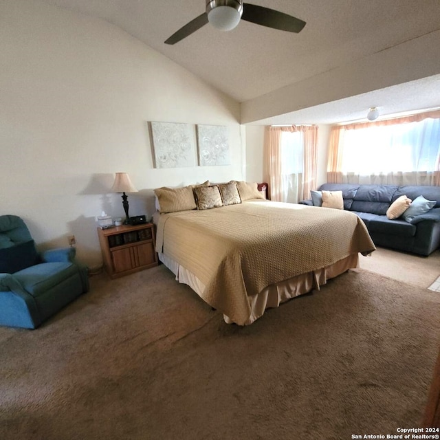 carpeted bedroom featuring ceiling fan and vaulted ceiling